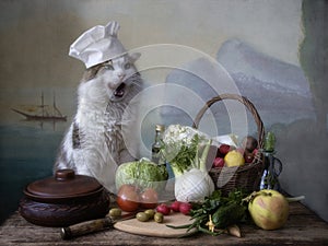 Mediterranean vegetarian still life with a cat in a chef`s hat