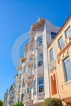 Mediterranean and victorian apartment buildings in a row at San Francisco, CA