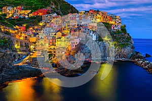 Mediterranean village with harbor at evening, Manarola, Cinque Terre, Italy