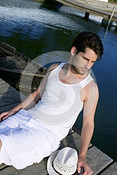 Mediterranean young man relaxed on wood pier