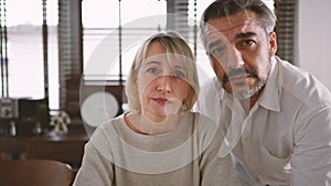 Medium close up shot of Caucasian man and woman talking with camera. Online meeting family for social distancing while coronavirus