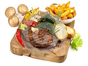 Medium Grilled Beef Steak on a wooden Board with Potato Wedges - Isolated