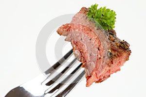 Medium grilled rumpsteak on a fork