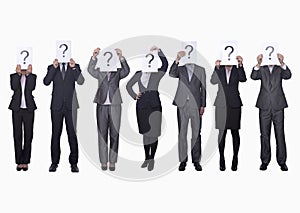 Medium group of business people in a row holding up paper with question mark, obscured face, studio shot