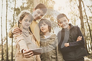 Medium group of kids making self portrait. Little girl holding