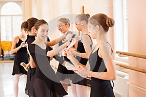 Medium group of teenage girls having fun and relaxing after ballet class