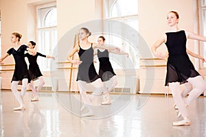 Medium group of teenage girls practicing classical ballet