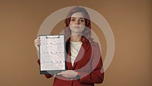 Medium isolated shot of a calm and relaxed young woman holding a folder, planchette in her hands and explaining the