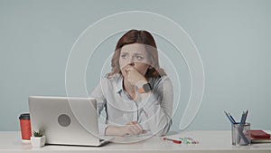 Medium isolated video of a stressed and nervous young woman looking at the screen of her laptop, anxiously waiting for