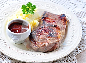 Medium rare grilled Beef steak with mashed potatoes and barbecue sauce