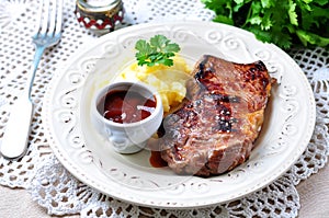 Medium rare grilled Beef steak with mashed potatoes and barbecue sauce