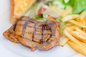 Medium rare grilled beef steak on on wooden black background wit