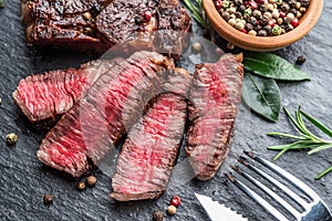 Medium rare Ribeye steak with herbs on graphite board