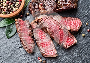 Medium rare Ribeye steak with herbs on graphite board