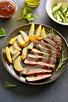 Medium rare roast beef with potato wedges