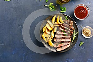 Medium rare roast beef with potato wedges