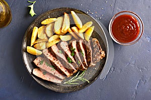 Medium rare roast beef with potato wedges