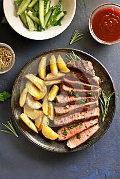 Medium rare roast beef with potato wedges