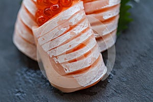 Medium Rare Salmon Sashimi Served with Ikura Salmon Roe and Sliced Radish in Stone Plate