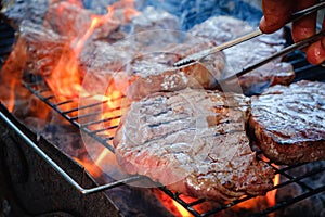 Medium rare sliced grilled striploin beef steak. Barbecue meat on the grill