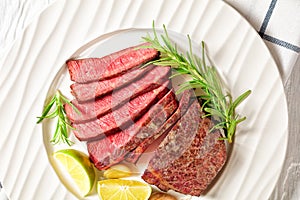 Medium rare steak beef striploin on a white plate