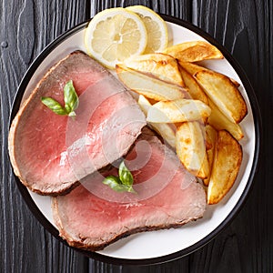 Medium roasted beef steak with potatoes close-up on a plate. top