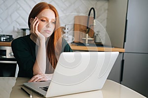 Medium shot of bored young woman office worker tired unmotivated and disinterested in dull work with laptop.