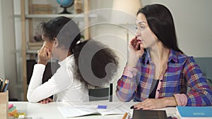 Medium shot of creative mother helping her daughter working together