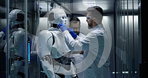 Engineers testing on robot controls inside the laboratory
