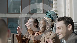 Medium shot of happy business partners laughing together outdoor