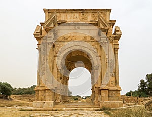 Medium shot of the iconic Arch of Septimius Severus at the ancient Roman ruins of Leptis Magna in Libya