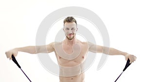 Medium shot of a muscular bodybuilder doing arm exercises with a resistance band on a white background