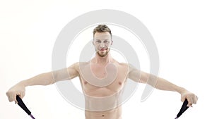 Medium shot of a muscular bodybuilder doing arm exercises with a resistance band on a white background