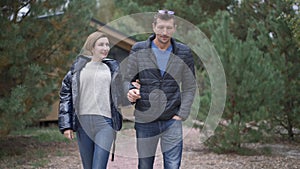 Medium shot portrait smiling loving adult happy couple walking outdoors talking. Romantic Caucasian man and woman