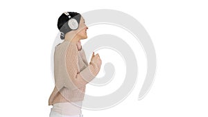 Smiling female with headphones walking and enjoying the music on