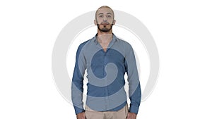 Strict arabic man standing and looking into camera on white background.