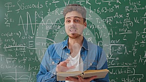 Medium shot of teacher with book holding math class