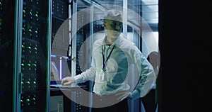 Technicians work on a laptop in a data center