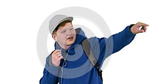 Teenager boy calling on mobile phone using handsfree while walki