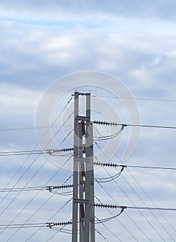 Medium voltage pylon with ceramic insulated wires to protect against electric shock and a large number of electric wires on a blue
