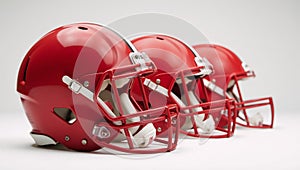 Mediumshot image featuring red American football helmets against a white backdrop