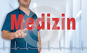Medizin in german Medical doctor showing on viewer with heart photo