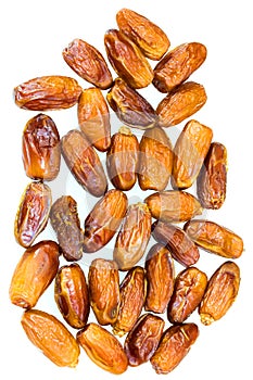 Medjool dates scattered on a white background.