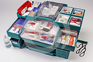 medkit, with surgical instruments and supplies arranged neatly inside