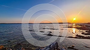 Medulin - Beautiful sunset at rocky beach in coastal town Medulin, Istria peninsula, Croatia, Europe. Romantic view photo