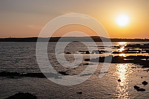 Medulin - Beautiful sunset at rocky beach in coastal town Medulin, Istria peninsula, Croatia, Europe. Romantic view