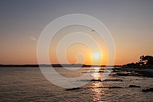 Medulin - Beautiful sunset at rocky beach in coastal town Medulin, Istria peninsula, Croatia, Europe. Romantic view