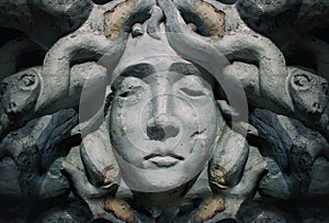 Medusa goddess face bas-relief statue.