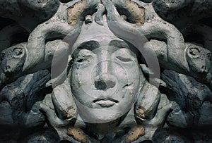 Medusa goddess face bas-relief statue. photo