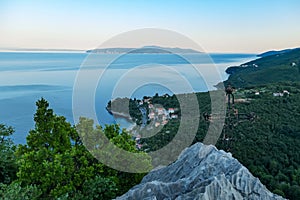 Medveja - A small metal cross on a rock with a panoramic view of the shore